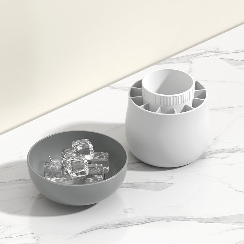 Silicone ice block mold and a bowl of ice cubes on a marble countertop, showcasing one-press easy release functionality.