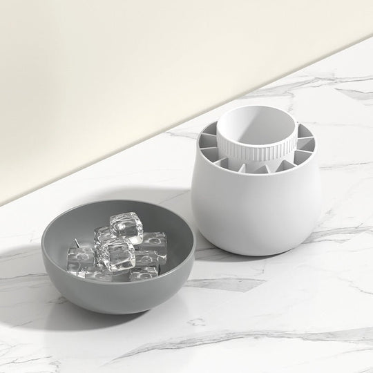 Silicone ice block mold and a bowl of ice cubes on a marble countertop, showcasing one-press easy release functionality.