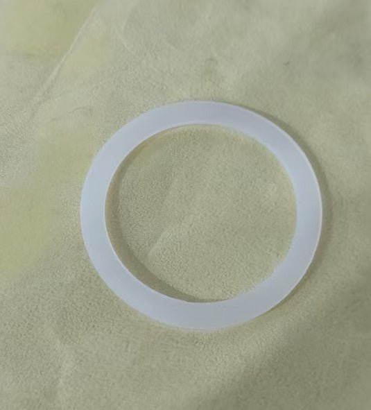 Spray water bottle replacement silicone ring on a soft yellow background.